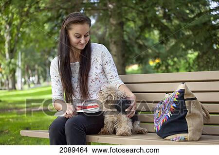 Picture - Young woman with her dog in a park; edmonton, alberta, canada. Fotosearch