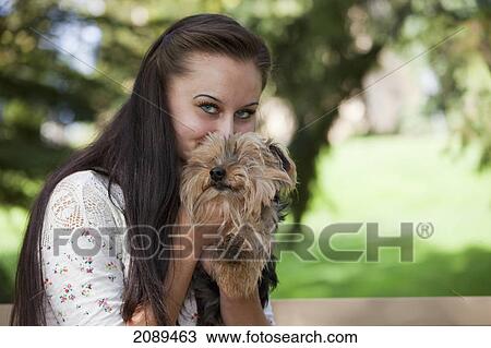 Young woman with her dog in a park; edmonton, alberta, canada View Large Photo Image Stock Image - Young woman with her dog in a park; edmonton, alberta, canada. Fotosearch