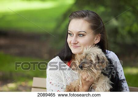 Young woman with her dog in a park; edmonton, alberta, canada View Large Photo Image Stock Photography - Young woman with her dog in a park; edmonton, alberta, canada. Fotosearch