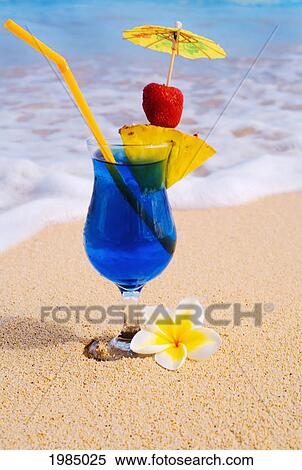 A Blue Hawaii Tropical Cocktail On The Beach, Wave Washing On The Sand. View Large Photo Image Stock Photography - A Blue Hawaii Tropical Cocktail On The Beach, Wave Washing On The Sand.. Fotosearch