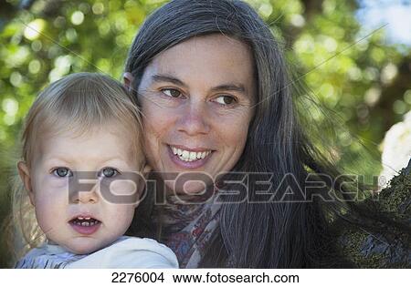 A mother and her young daughter smiling in a portrait; british columbia canada View Large Photo Image Picture - A mother and her young daughter smiling in a portrait; british columbia canada. Fotosearch