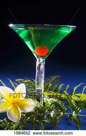 A Sour Apple Martini On A Blue Background With Green Fern And Plumeria. View Large Photo Image Stock Image - A Sour Apple Martini On A Blue Background With Green Fern And Plumeria.. Fotosearch