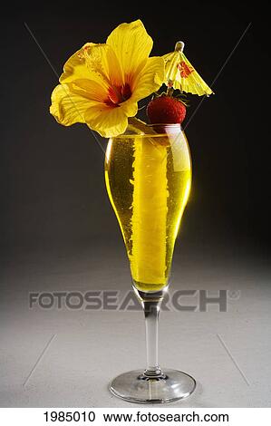 A Tropical Cocktail Garnished With Pineapple Rind, A Strawberry And Hibiscus. View Large Photo Image Stock Image - A Tropical Cocktail Garnished With Pineapple Rind, A Strawberry And Hibiscus.. Fotosearch