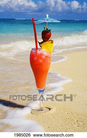 A Tropical Cocktail On The Beach, Wave Washing On The Sand. View Large Photo Image Stock Photograph - A Tropical Cocktail On The Beach, Wave Washing On The Sand.. Fotosearch