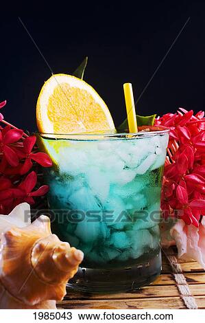 A Tropical Drink Garnished With Flowers And Fruit. View Large Photo Image Stock Image - A Tropical Drink Garnished With Flowers And Fruit.. Fotosearch