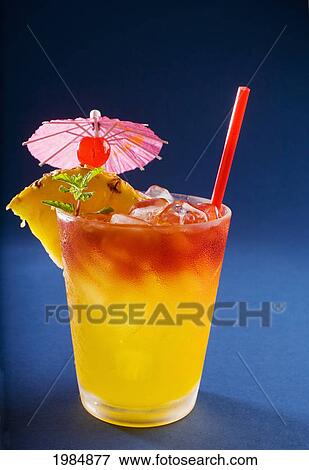 A Tropical Drink Garnished With Fruit And Flowers. View Large Photo Image Stock Photo - A Tropical Drink Garnished With Fruit And Flowers.. Fotosearch