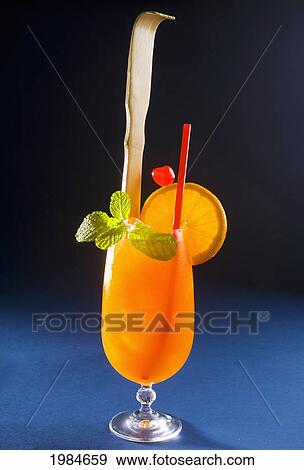 A Tropical Itch Cocktail Garnished With Fruit And A Backscratcher. View Large Photo Image Stock Photo - A Tropical Itch Cocktail Garnished With Fruit And A Backscratcher.. Fotosearch