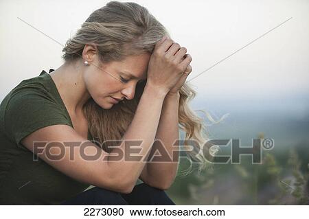 Stock Image - A woman praying; arvada colorado united states of america. Fotosearch