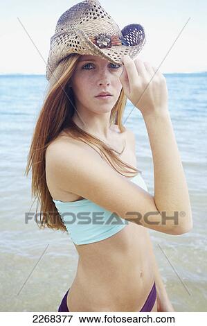 A young woman posing by the ocean; kauai hawaii united states of america View Large Photo Image Stock Photo - A young woman posing by the ocean; kauai hawaii united states of america. Fotosearch