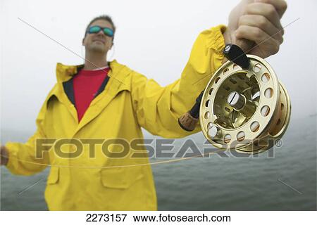 Angler with a fly rod and reel fishing in boston harbour; boston massachusetts united states of america View Large Photo Image Stock Photo - Angler with a fly rod and reel fishing in boston harbour; boston massachusetts united states of america. Fotosearch