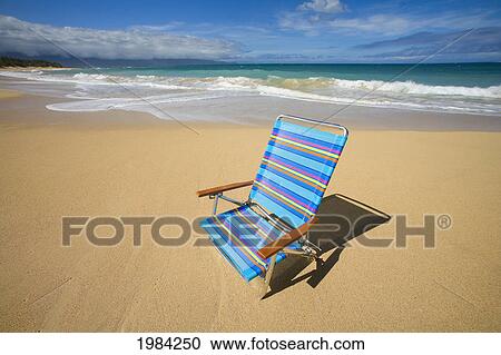 Brightly Colored Beach Chair On The Sand Near The Ocean. View Large Photo Image Stock Image - Brightly Colored Beach Chair On The Sand Near The Ocean.. Fotosearch