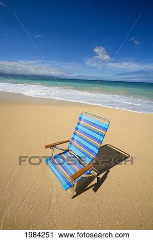Brightly Colored Beach Chair On The Sand Near The Ocean. View Large Photo Image Stock Image - Brightly Colored Beach Chair On The Sand Near The Ocean.. Fotosearch