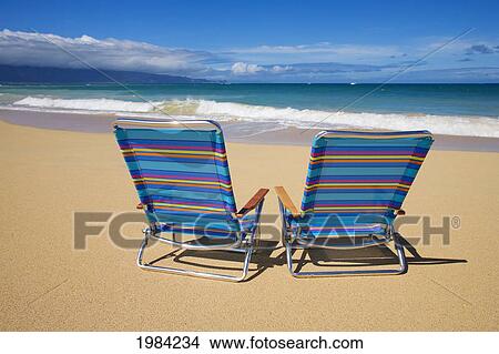 Brightly Colored Beach Chairs On The Sand Near The Ocean. View Large Photo Image Picture - Brightly Colored Beach Chairs On The Sand Near The Ocean.. Fotosearch