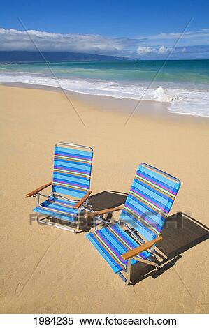 Stock Photography - Brightly Colored Beach Chairs On The Sand Near The Ocean.. Fotosearch
