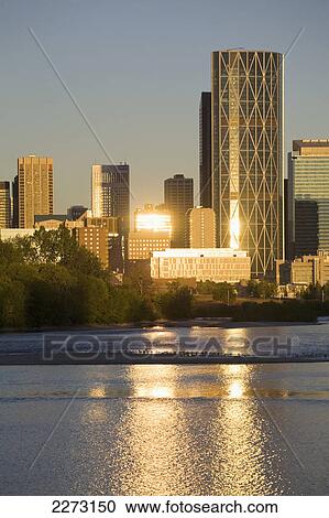 Calgary cityscape along river with reflections on buildings and river at sunrise with blue sky; calgary alberta canada View Large Photo Image Stock Image - Calgary cityscape along river with reflections on buildings and river at sunrise with blue sky; calgary alberta canada. Fotosearch
