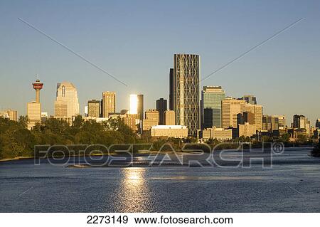 Calgary cityscape along river with reflections on building and river at sunrise with blue sky; calgary alberta canada View Large Photo Image Stock Photo - Calgary cityscape along river with reflections on building and river at sunrise with blue sky; calgary alberta canada. Fotosearch