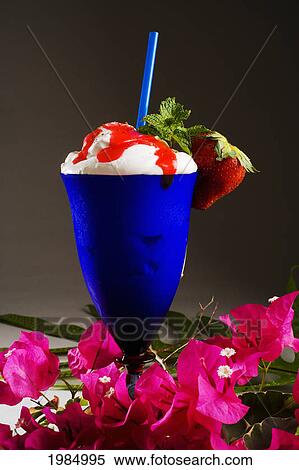 Close-Up Of A Blue Cocktail Glass Filled With A Creamy Tropical Drink Dripping With Strawberry Syrup. View Large Photo Image Stock Photography - Close-Up Of A Blue Cocktail Glass Filled With A Creamy Tropical Drink Dripping With Strawberry Syrup.. Fotosearch