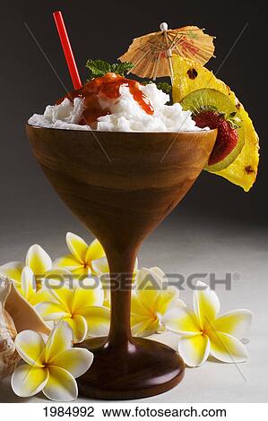 Stock Image - Close-Up Of A Koa Cocktail Glass Filled With A Creamy Tropical Drink Dripping With Strawberry Syrup.. Fotosearch