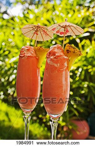 Close-Up Of Two Glasses Filled With A Creamy Pink Tropical Drink. View Large Photo Image Stock Image - Close-Up Of Two Glasses Filled With A Creamy Pink Tropical Drink.. Fotosearch