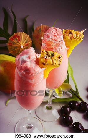 Stock Photo - Close-Up Of Two Glasses Filled With A Creamy Pink Tropical Drink.. Fotosearch