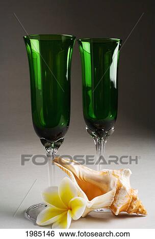 Close-Up Of Two Green Champagne Glasses With A Seashell And Flower. View Large Photo Image Stock Photograph - Close-Up Of Two Green Champagne Glasses With A Seashell And Flower.. Fotosearch
