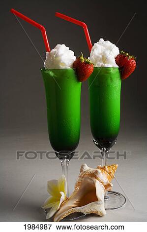 Stock Photo - Close-Up Of Two Green Glasses Filled With A Creamy Tropical Drink.. Fotosearch
