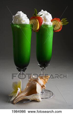 Close-Up Of Two Green Glasses Filled With A Creamy Tropical Drink. View Large Photo Image Stock Photograph - Close-Up Of Two Green Glasses Filled With A Creamy Tropical Drink.. Fotosearch