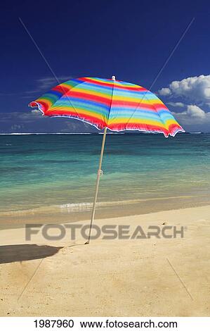 Colorful Beach Umbrella On The Shoreline Of A Tropical Beach, Calm Water Lapping On The Shore. View Large Photo Image Stock Image - Colorful Beach Umbrella On The Shoreline Of A Tropical Beach, Calm Water Lapping On The Shore.. Fotosearch