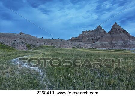 Early morning in badlands national park with deer on a ridge silhouetted against the brightening sky; south dakota united states of america View Large Photo Image Stock Photo - Early morning in badlands national park with deer on a ridge silhouetted against the brightening sky; south dakota united states of america. Fotosearch