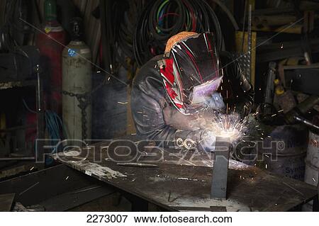 Female welder welding in a shop; edmonton alberta canada View Large Photo Image Stock Photo - Female welder welding in a shop; edmonton alberta canada. Fotosearch