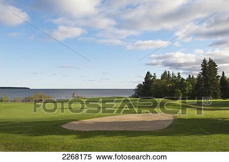 Stock Photography - Golf course putting green and pin on lake; hecla island manitoba canada. Fotosearch