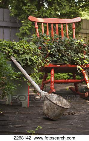 Stock Image - Home garden with various decor; winnipeg manitoba canada. Fotosearch