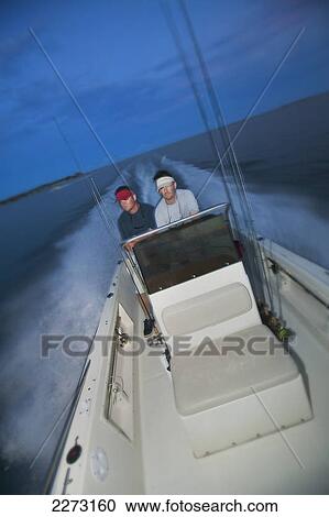 Men riding on a boat at dusk; north carolina united states of america View Large Photo Image Stock Image - Men riding on a boat at dusk; north carolina united states of america. Fotosearch