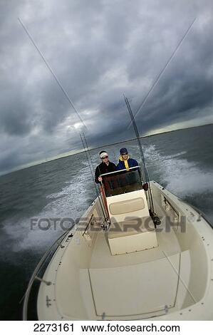 Men riding on a boat at dusk; north carolina united states of america View Large Photo Image Stock Image - Men riding on a boat at dusk; north carolina united states of america. Fotosearch