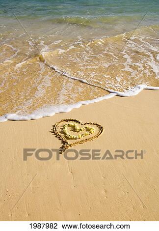 Picture Of A Heart Drawn In The Sand On A Tropical Beach, Yellow Lei Shaped Like A Heart Inside Of Drawing View Large Photo Image Stock Image - Picture Of A Heart Drawn In The Sand On A Tropical Beach, Yellow Lei Shaped Like A Heart Inside Of Drawing. Fotosearch