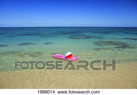 Picture - Pink Inflated Raft And Beachball On Clear Ocean Water.. Fotosearch