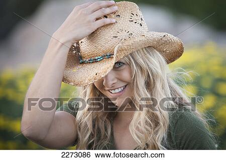 Portrait of a woman with long blond hair wearing a cowgirl hat; arvada colorado united states of america View Large Photo Image Stock Photograph - Portrait of a woman with long blond hair wearing a cowgirl hat; arvada colorado united states of america. Fotosearch