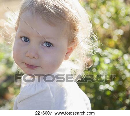 Stock Photo - Portrait of a young girl in a garden; british columbia canada. Fotosearch