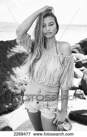 Portrait of a young woman on the beach at the water's edge; kauai hawaii united states of america View Large Photo Image Stock Photo - Portrait of a young woman on the beach at the water's edge; kauai hawaii united states of america. Fotosearch