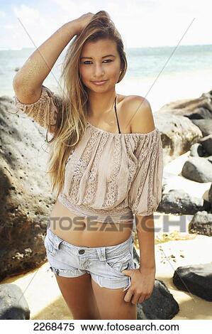 Portrait of a young woman on the beach at the water's edge; kauai hawaii united states of america View Large Photo Image Stock Photography - Portrait of a young woman on the beach at the water's edge; kauai hawaii united states of america. Fotosearch