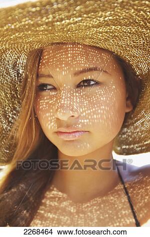Portrait of a young woman wearing a sunhat; kauai hawaii united states of america View Large Photo Image Picture - Portrait of a young woman wearing a sunhat; kauai hawaii united states of america. Fotosearch