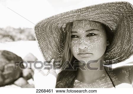 Portrait of a young woman wearing a sunhat; kauai hawaii united states of america View Large Photo Image Stock Image - Portrait of a young woman wearing a sunhat; kauai hawaii united states of america. Fotosearch