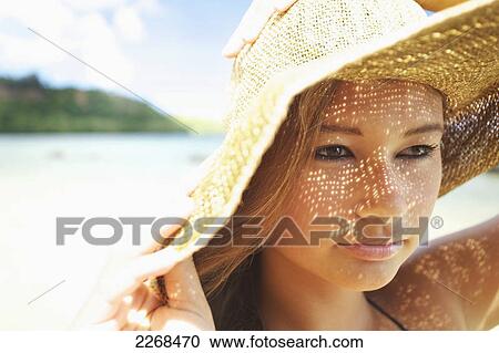 Portrait of a young woman wearing a sunhat; kauai hawaii united states of america View Large Photo Image Stock Image - Portrait of a young woman wearing a sunhat; kauai hawaii united states of america. Fotosearch