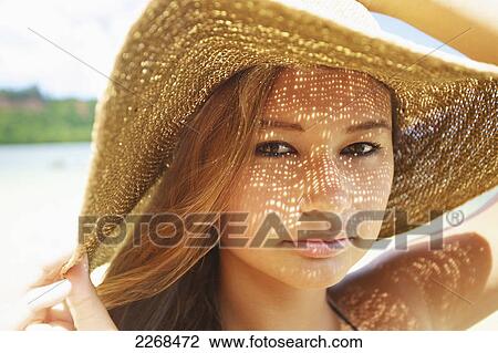 Portrait of a young woman wearing a sunhat; kauai hawaii united states of america View Large Photo Image Stock Image - Portrait of a young woman wearing a sunhat; kauai hawaii united states of america. Fotosearch