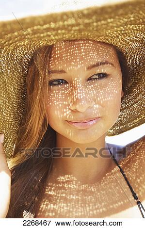 Portrait of a young woman wearing a sunhat; kauai hawaii united states of america View Large Photo Image Stock Photo - Portrait of a young woman wearing a sunhat; kauai hawaii united states of america. Fotosearch
