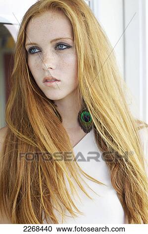 Stock Image - Portrait of a young woman with long red hair; kauai hawaii united states of america. Fotosearch