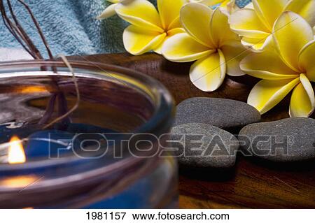 Stock Photo - Spa Elements, Candle, Flowers, And Grey Stones.. Fotosearch