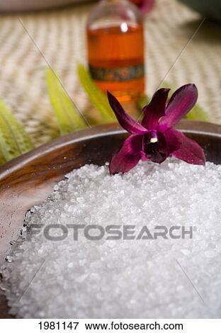 Spa Elements, Koa Bowl Filled With Raw Salt, Garnished With Orchid, Leaf And Bath Oil Blurred In Background. View Large Photo Image Stock Photo - Spa Elements, Koa Bowl Filled With Raw Salt, Garnished With Orchid, Leaf And Bath Oil Blurred In Background.. Fotosearch