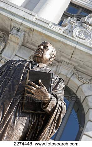 Statue of a man holding a bible; new orleans louisiana united states of america View Large Photo Image Stock Photo - Statue of a man holding a bible; new orleans louisiana united states of america. Fotosearch