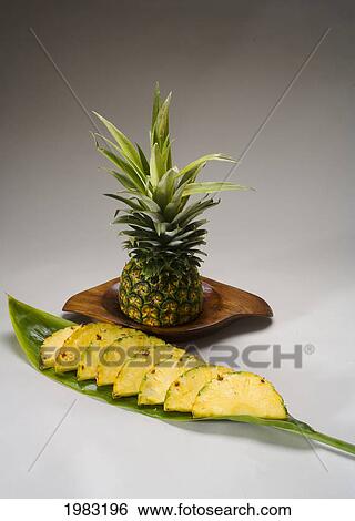 Stock Photograph - Studio Shot Of A Pineapple, Cut Into Slices.. Fotosearch